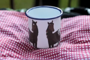 A mug with a portrait of horses - larger animals on a separate mug